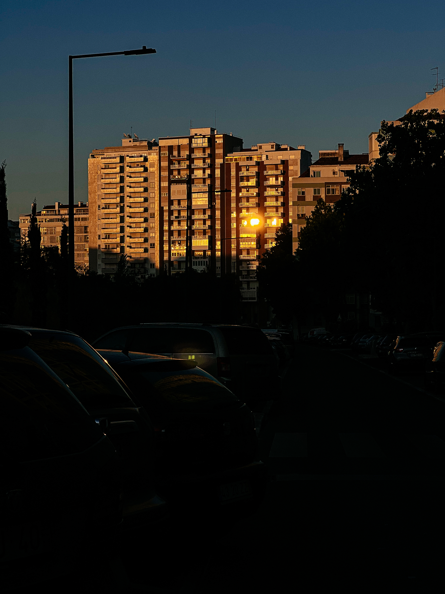 Buildings reflect the sun, at sunset. 