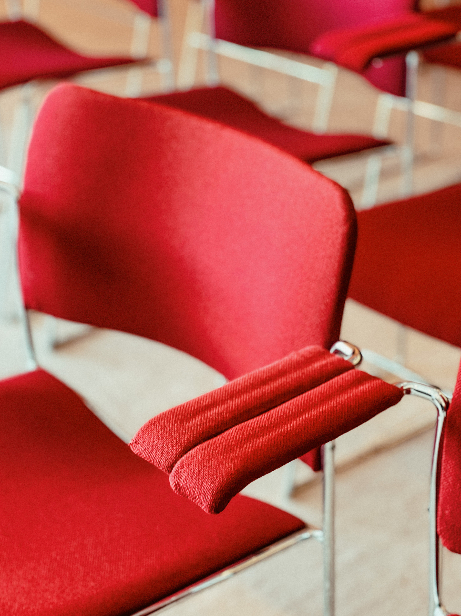 Red chairs in a conference room. 