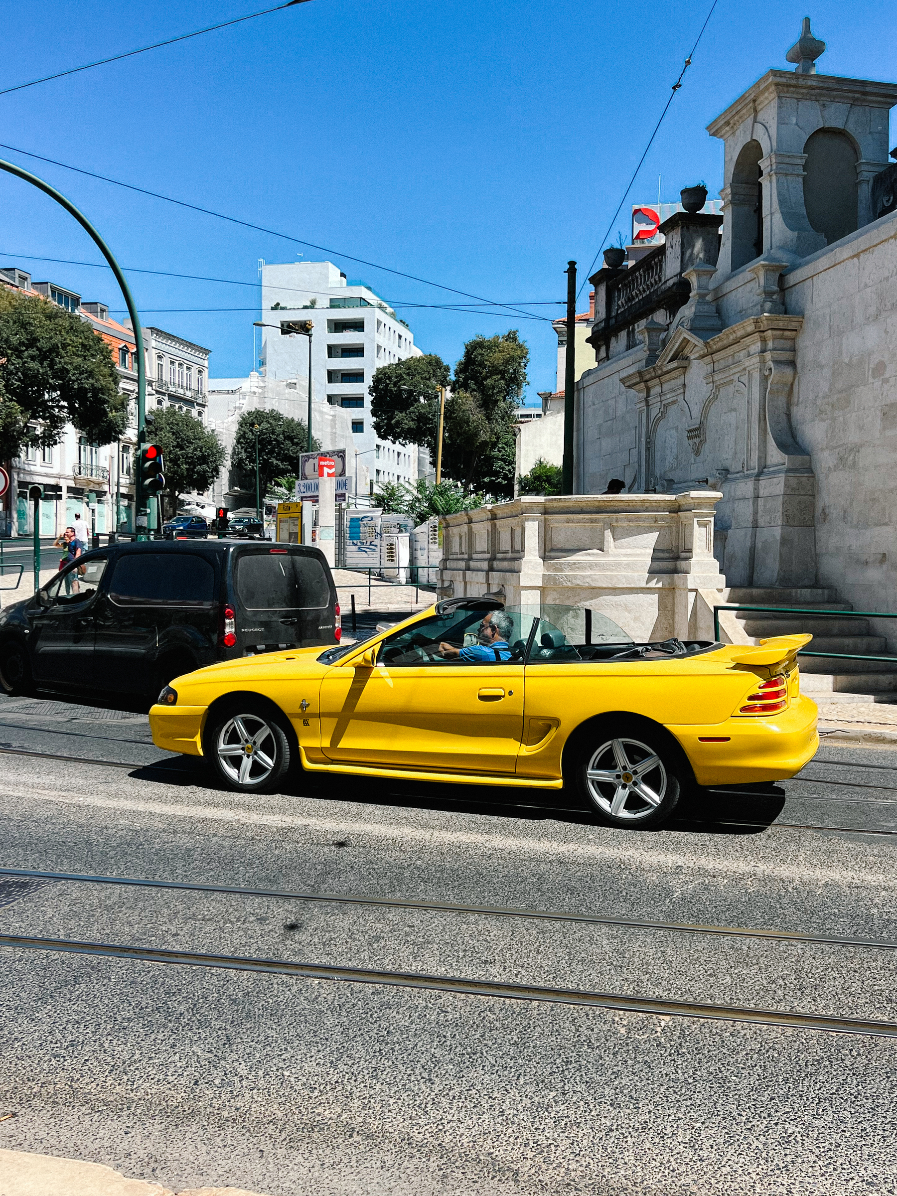 A yellow, convertible, Mustang. 
