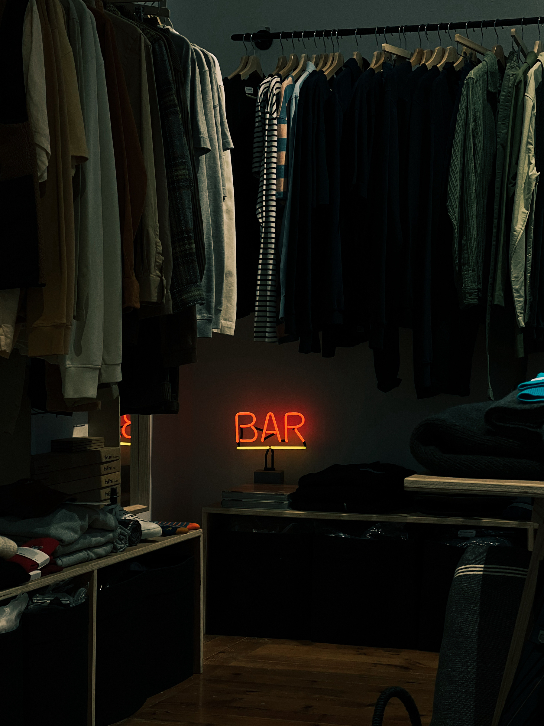 A neon sign for “Bar”, in a garment shop. 