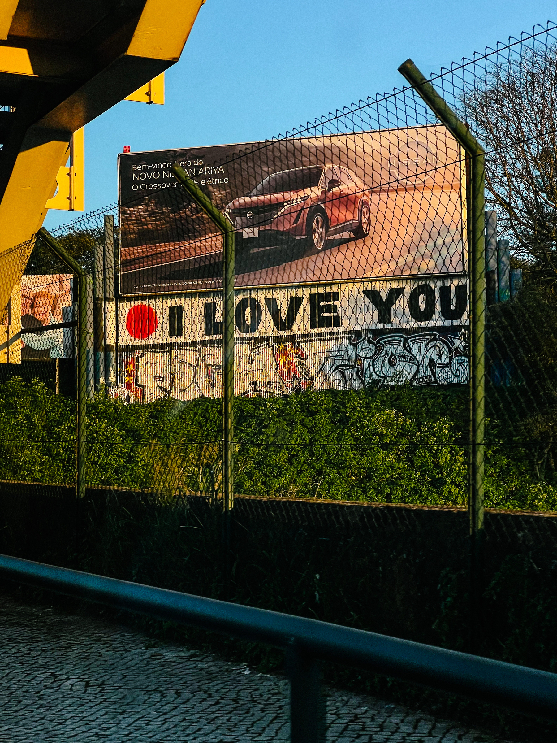 Ad for a car, with “I LOVE YOU” graffitied below. 