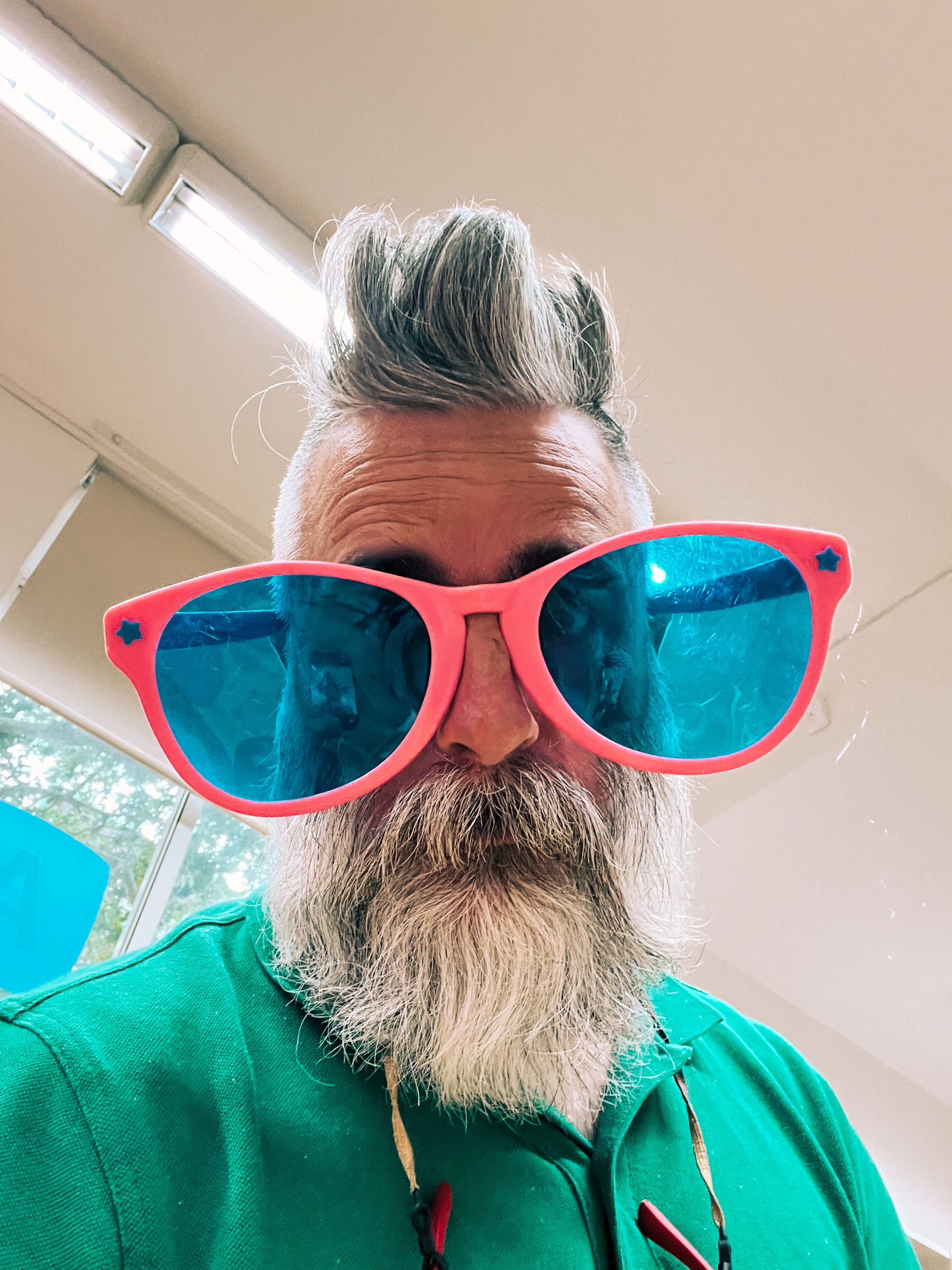 Selfie of a bearded man, with clownish oversized pink shades.