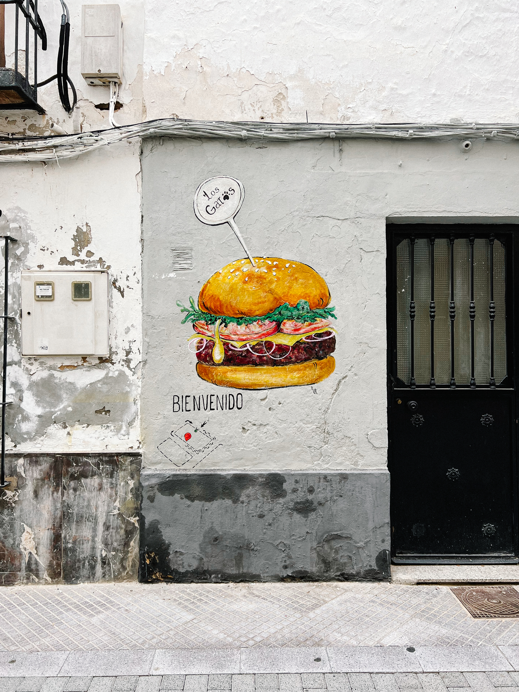 A burger painted on a very unremarkable wall. 