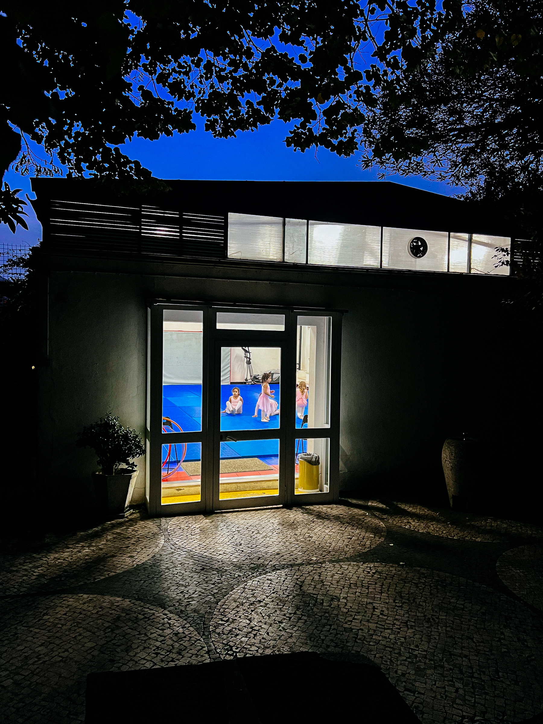 A ballet studio, seen from the outside, right after sunset.