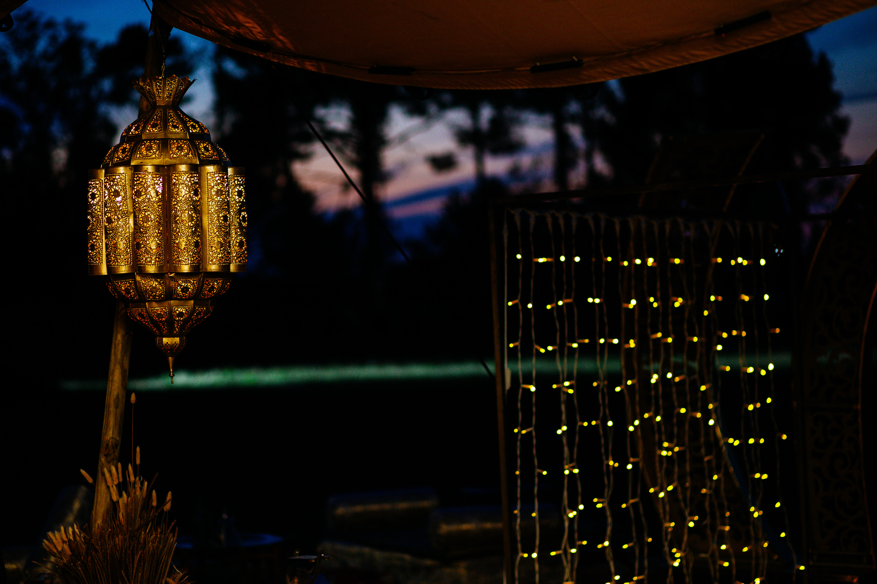 A Moroccan lamp, some dots of light, and a sunset in the back. 