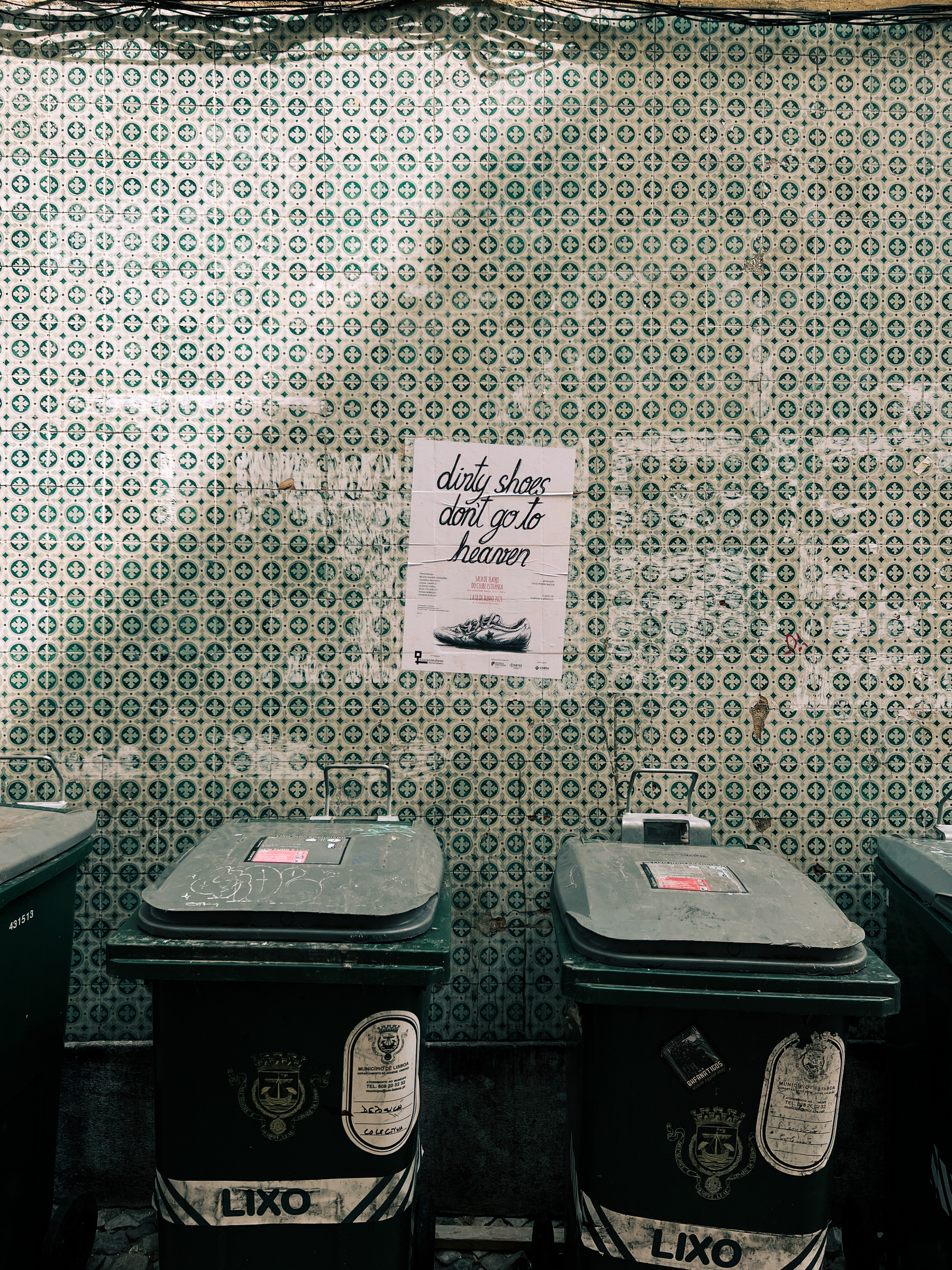 “dirty shoes don’t go to heaven”, on a poster, on a tile wall, over a couple of trash cans. 