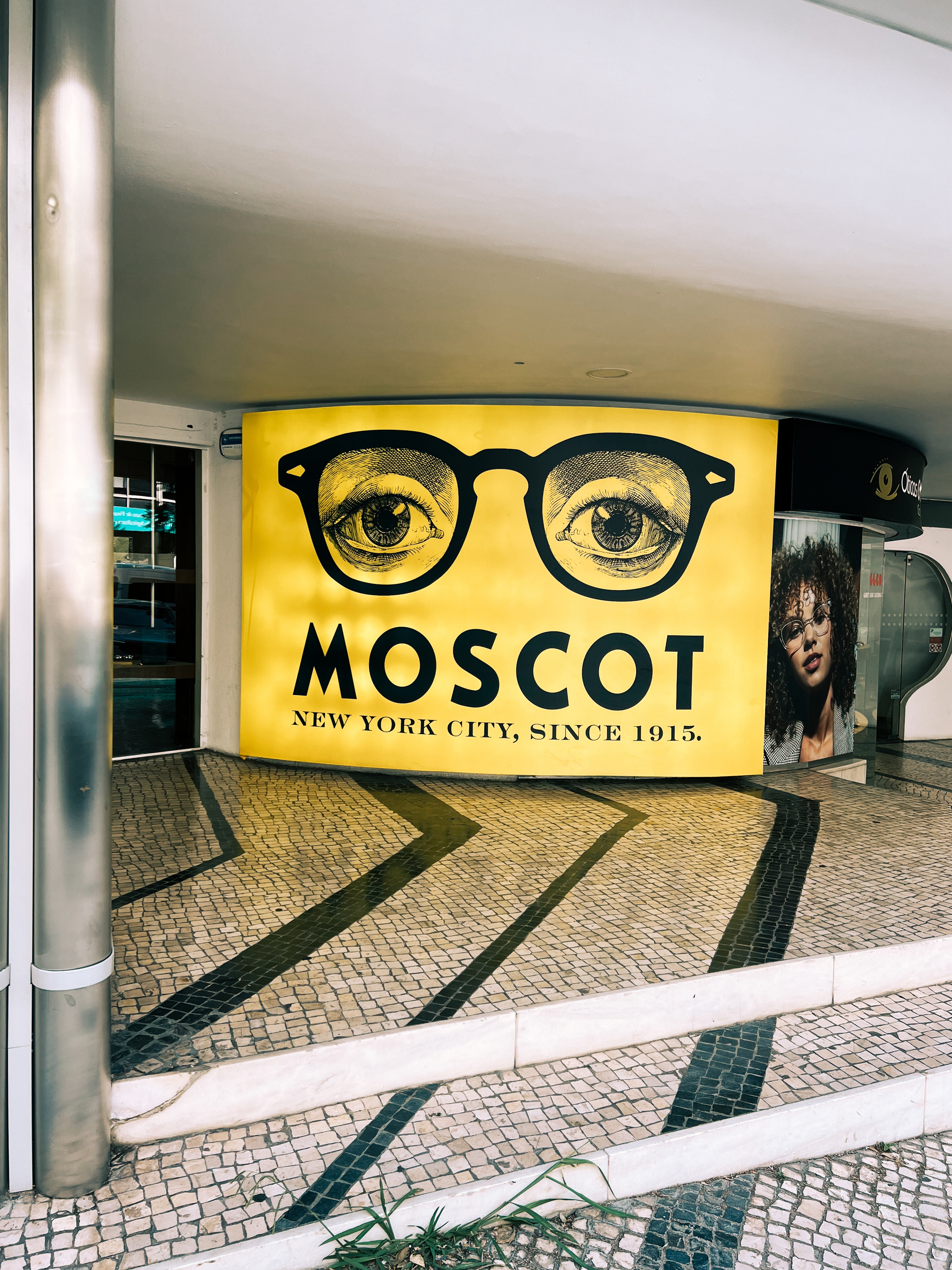 Ad for Moscot eyewear, yellow, with eyes wearing glasses.