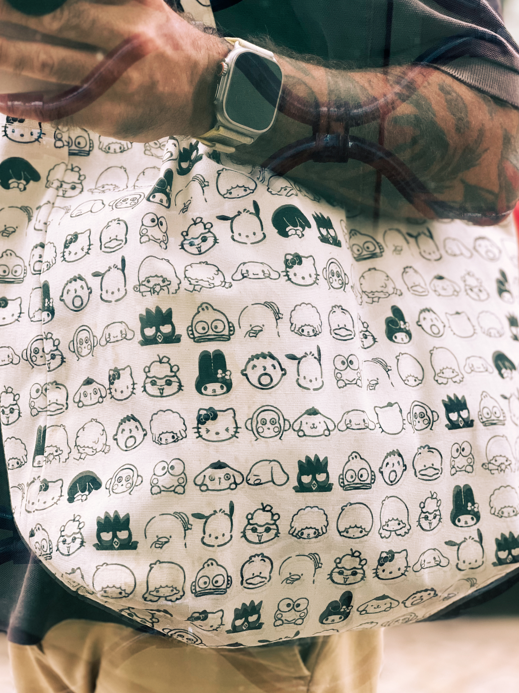 A selfie with my Sanrio tote, with lots of characters in black and white. 