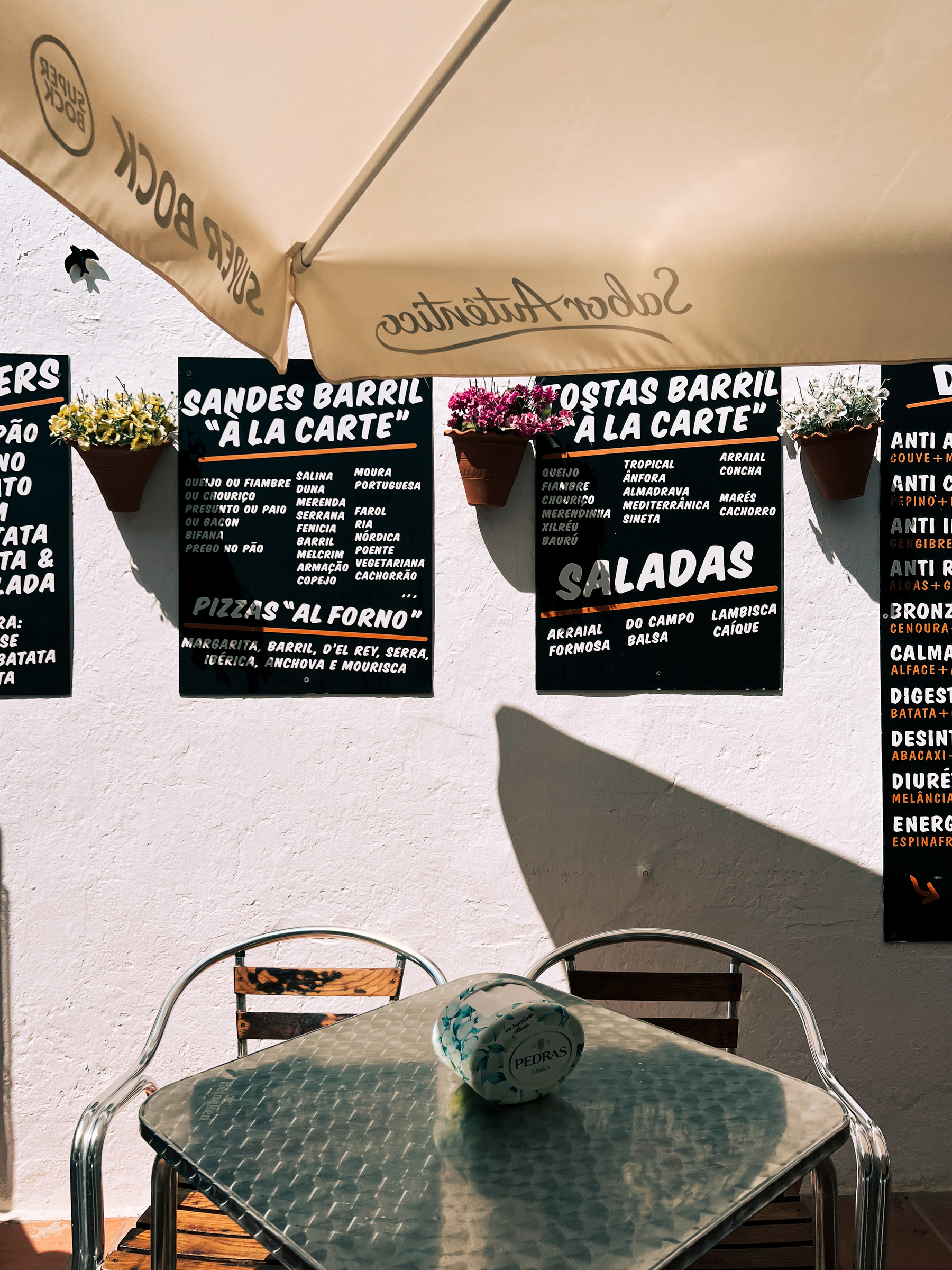 Menus hang from a wall next to a table. 