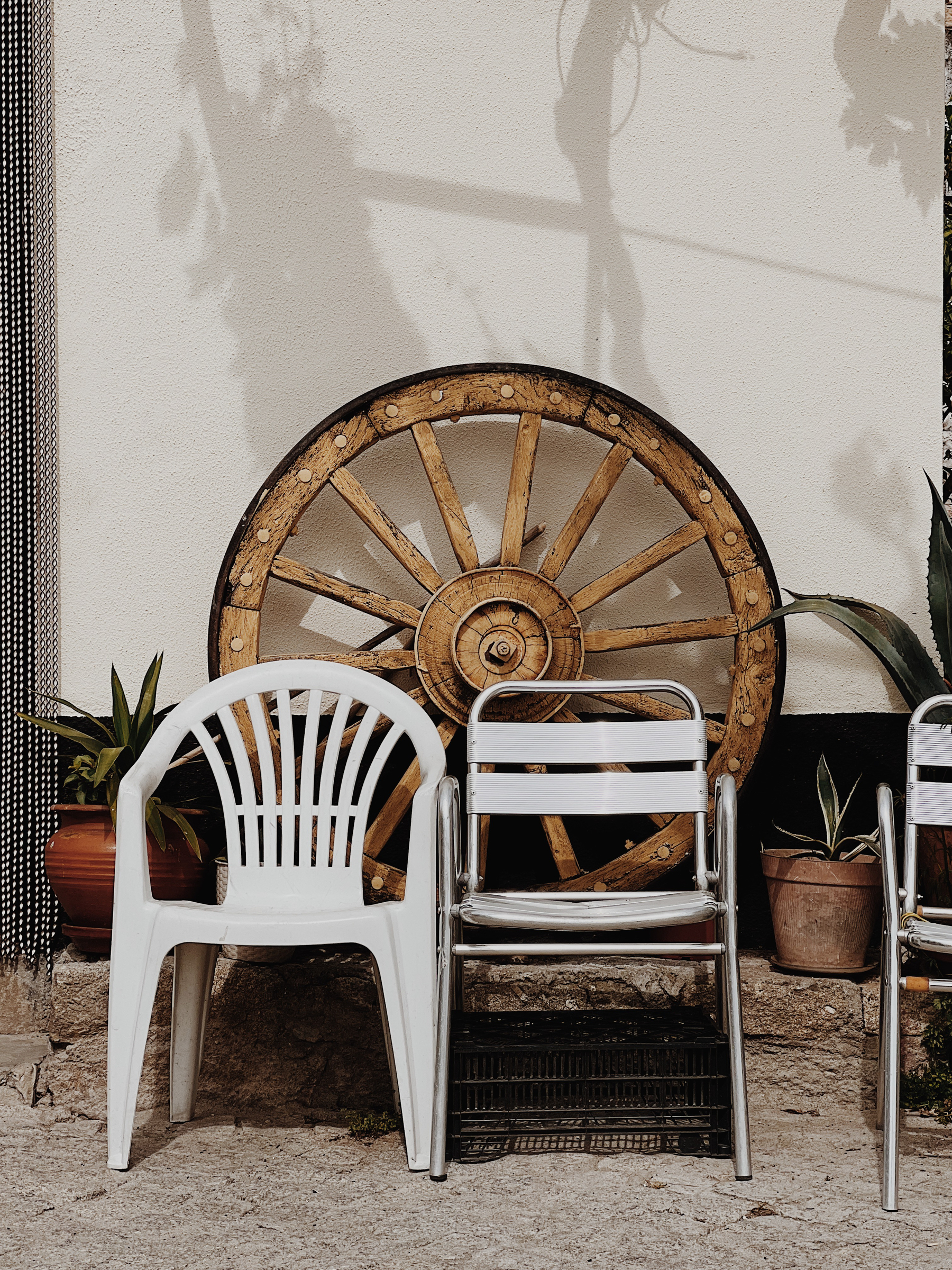 Chairs and a wagon wheel. 