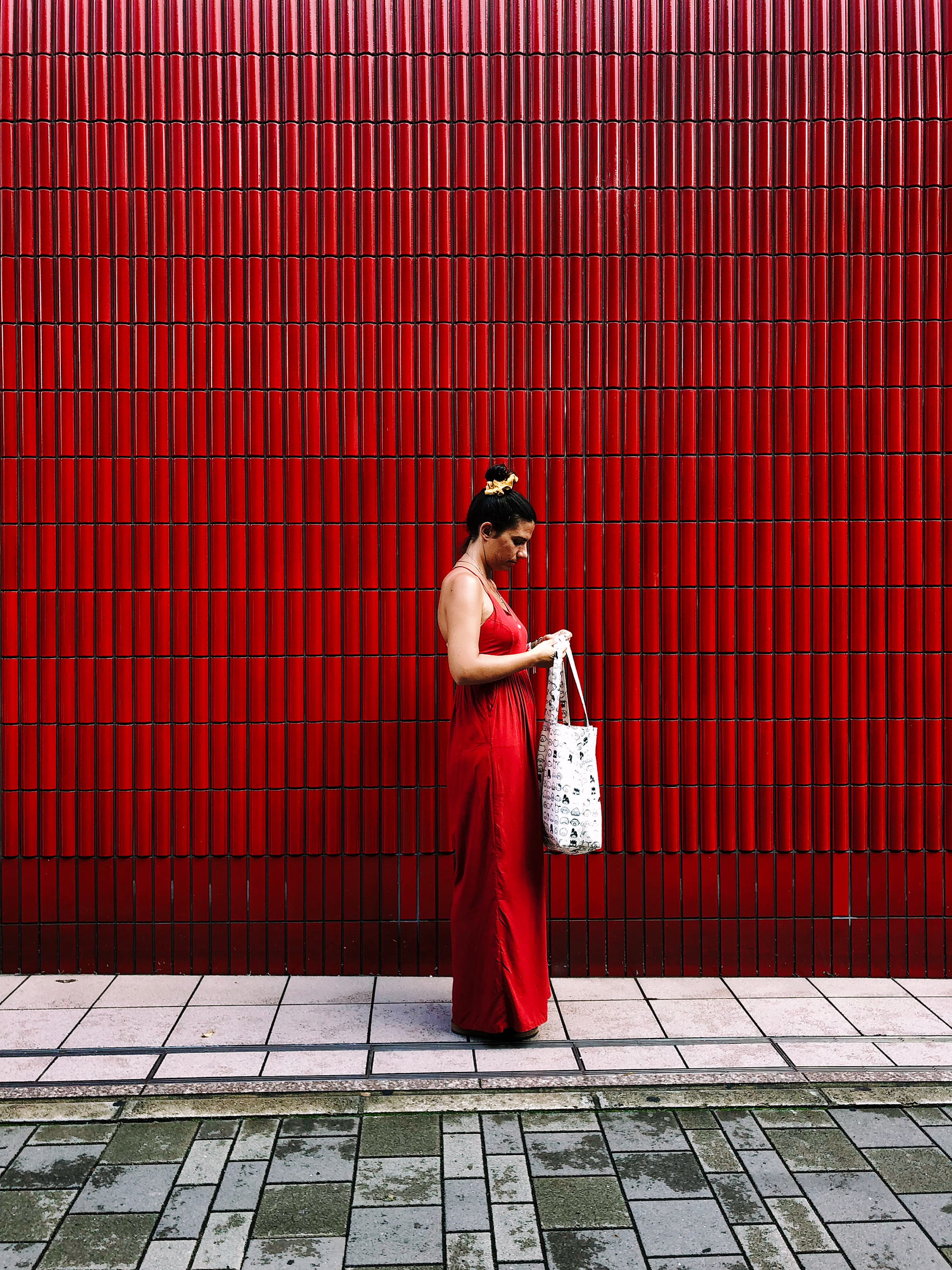a woman and a red wall.