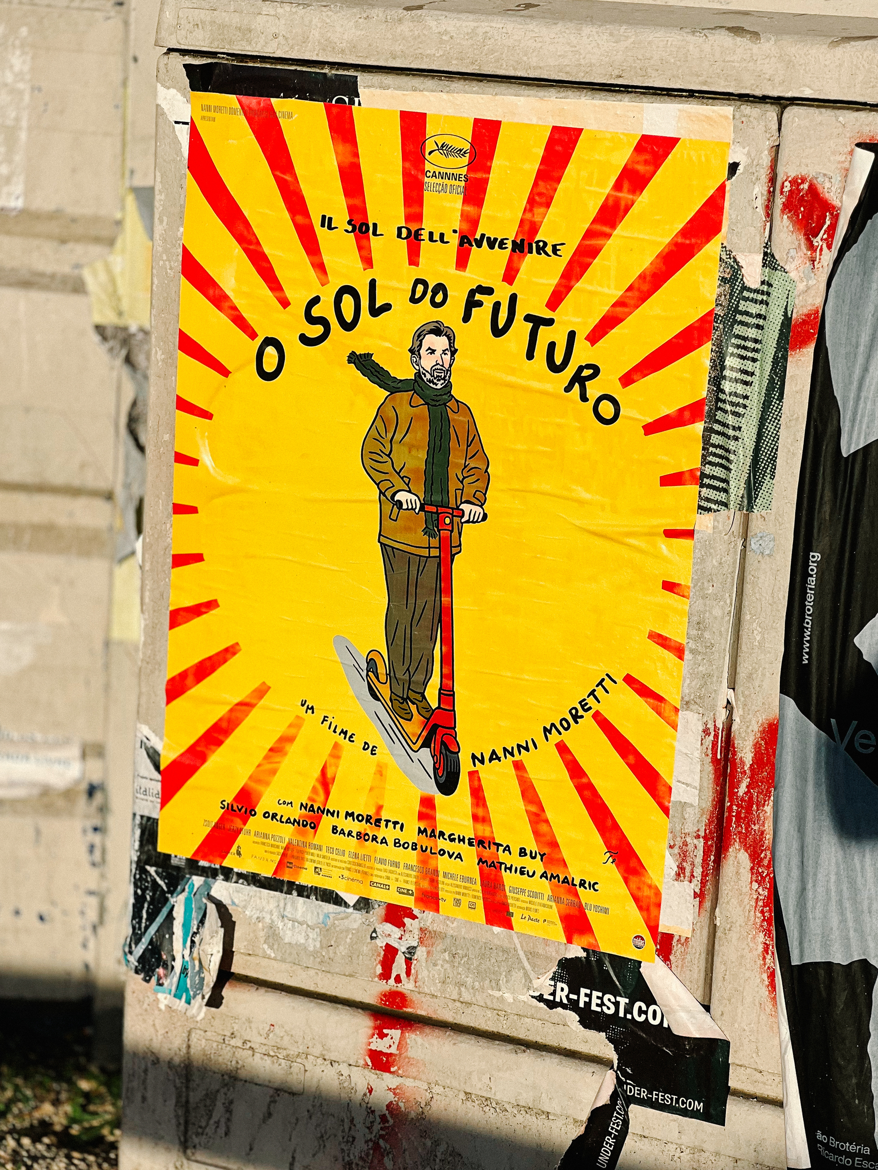 Poster of a Nanni Moretti movie, with a man riding a red scooter. 