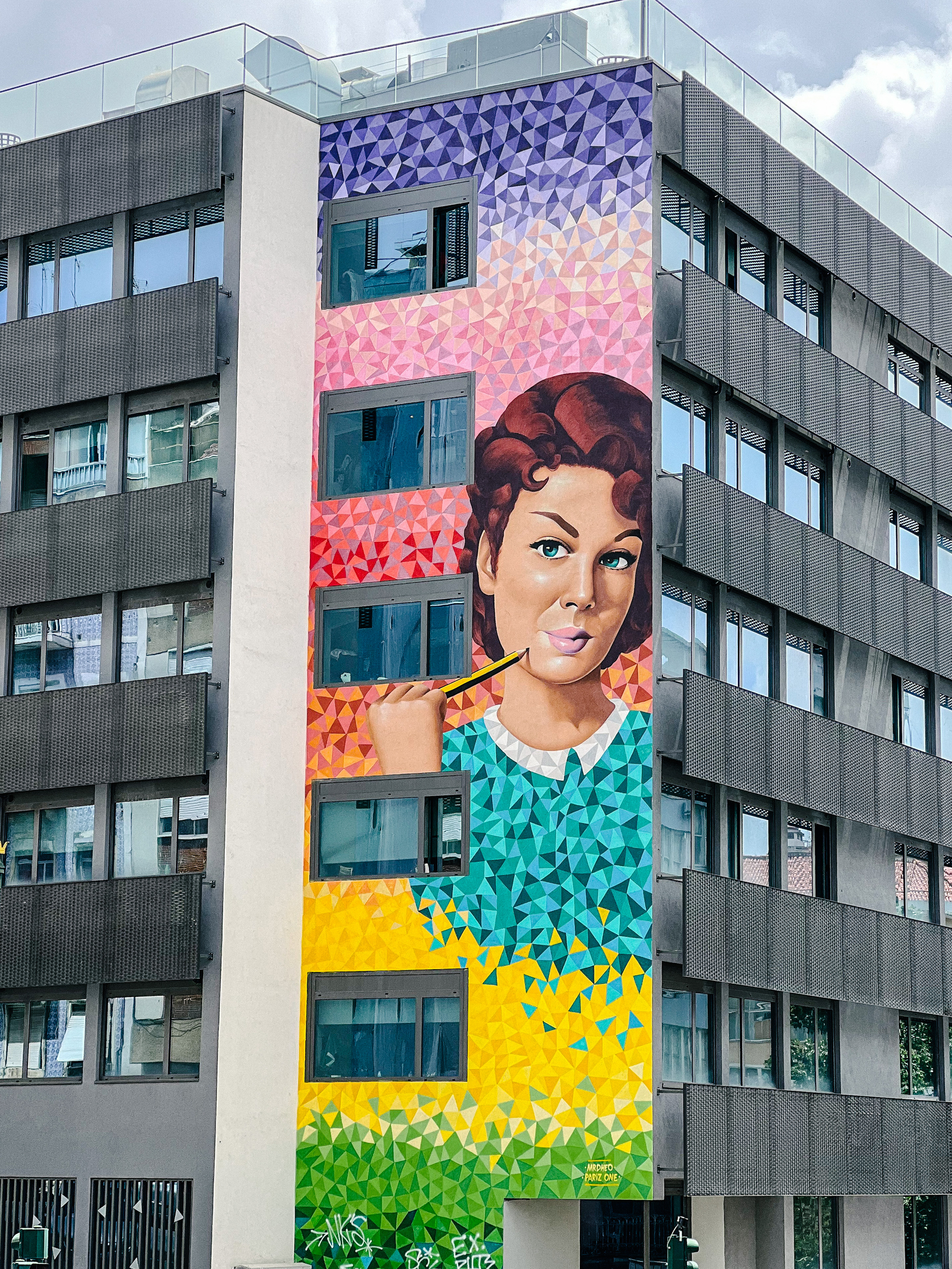 Street art piece, on the side of a building. A woman. 
