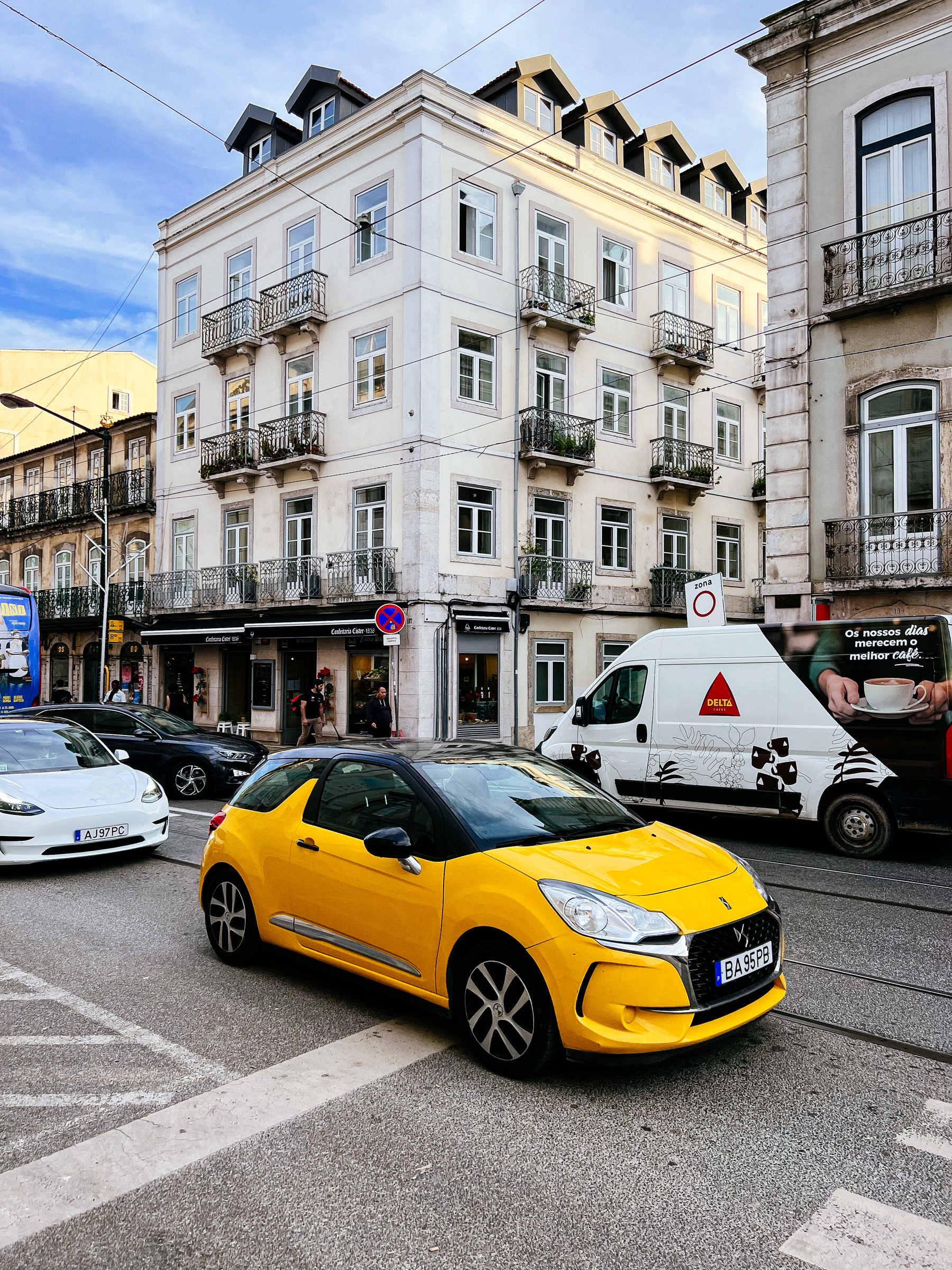 A yellow car drives by. 