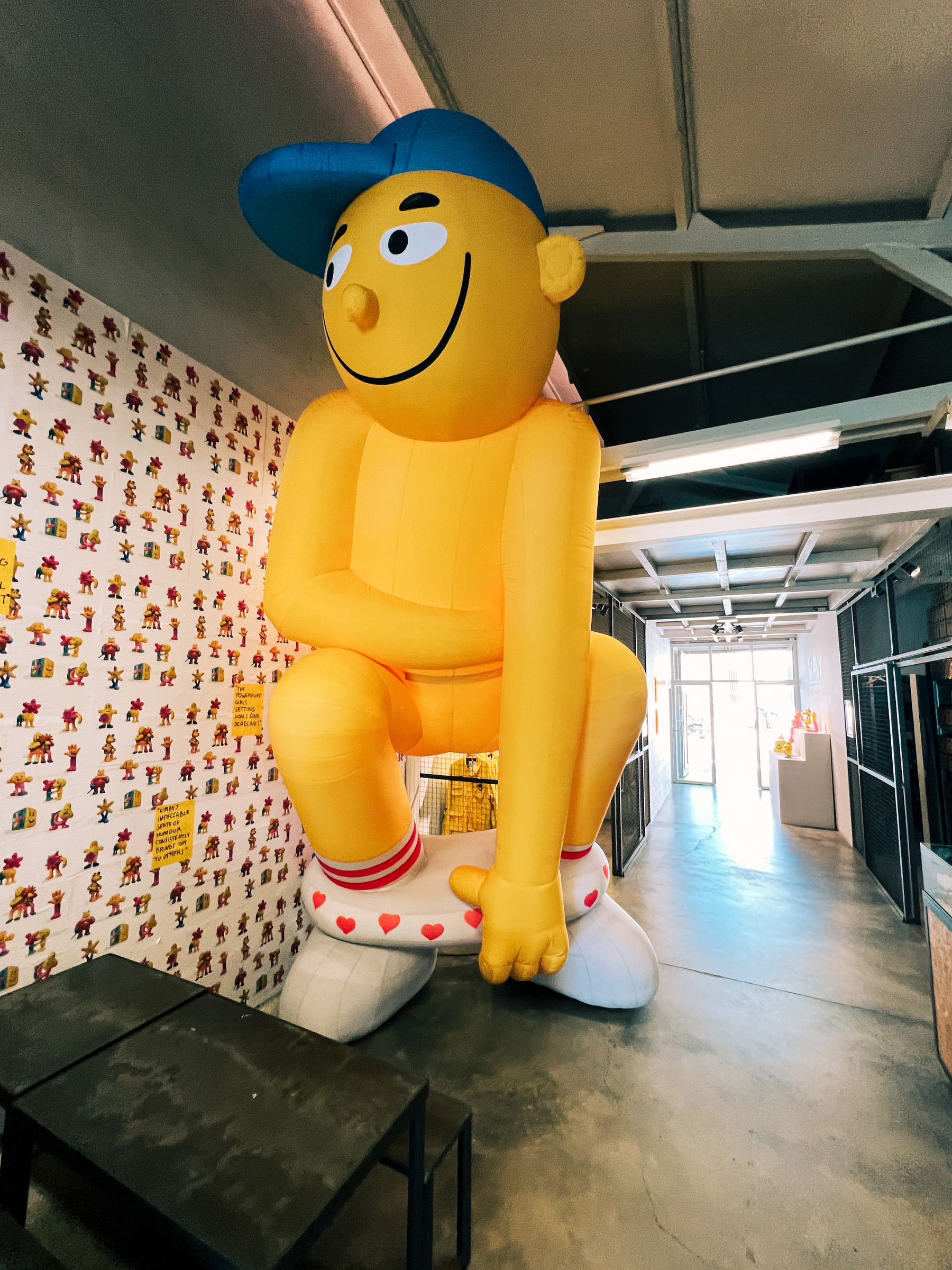 A giant inflatable toy. Floor to (high) ceiling. Yellow, with a blue cap. 