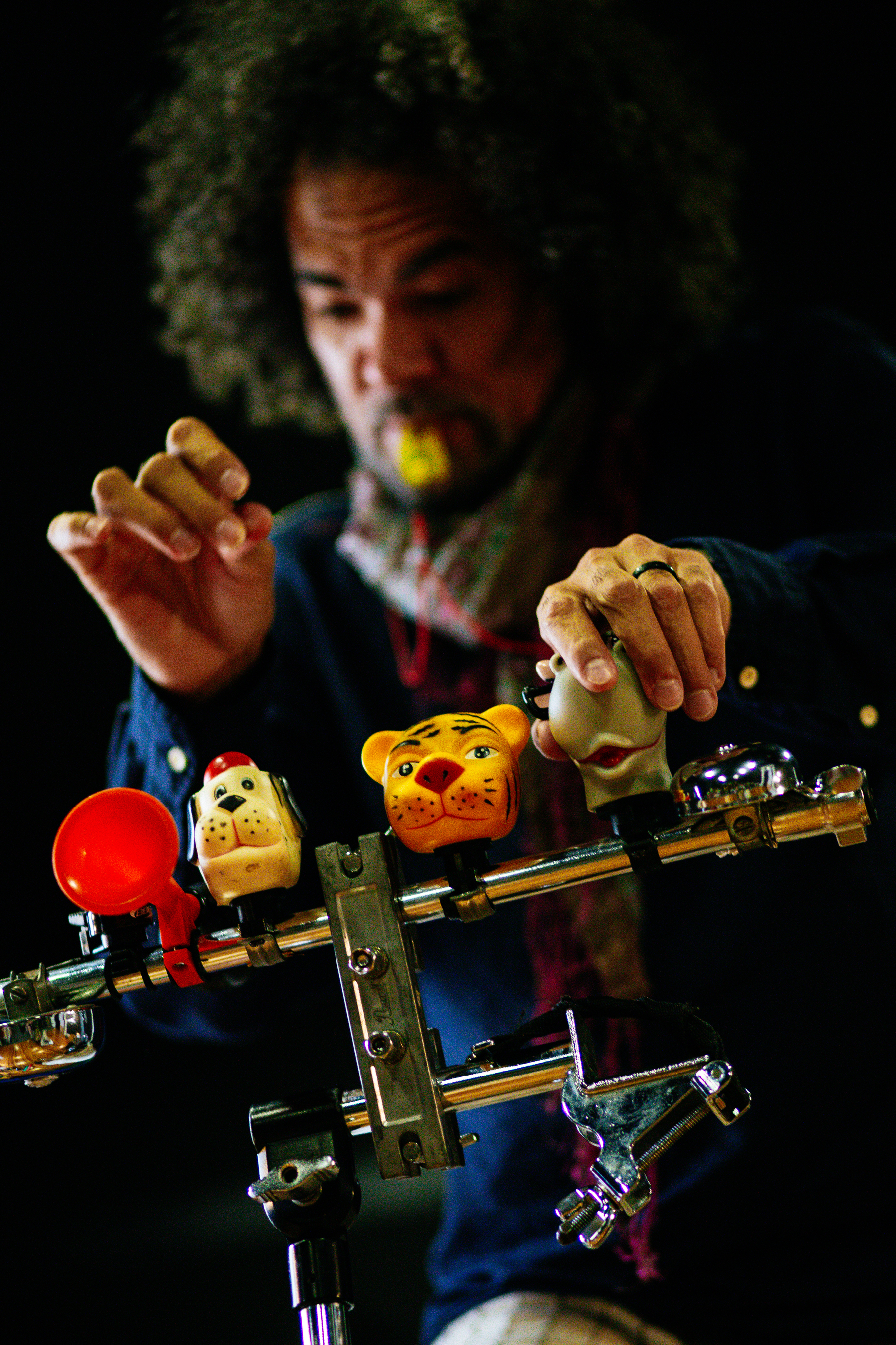 A musician plays child-themed tiny instruments.