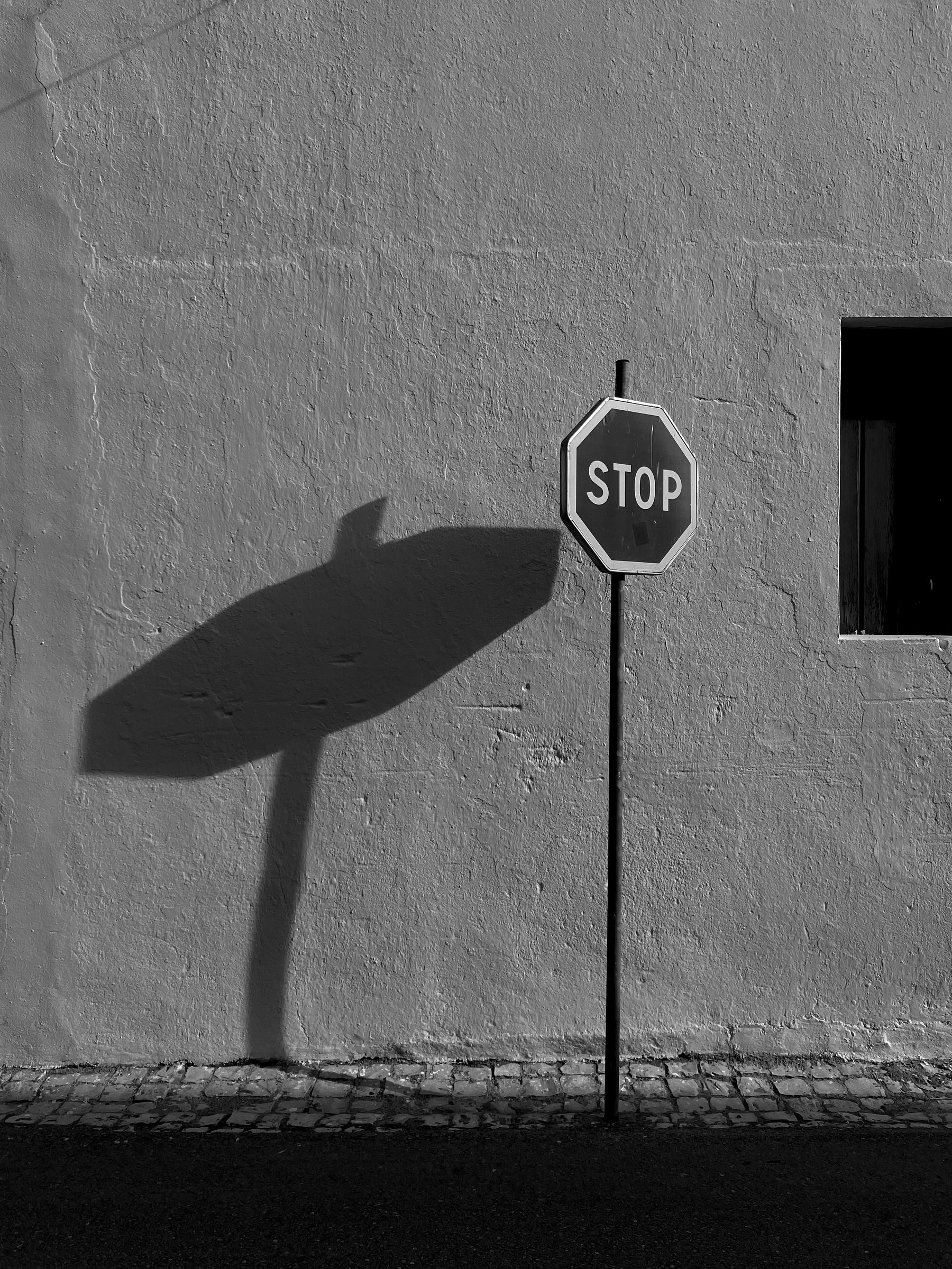 Black and white photo of a stop sign. 