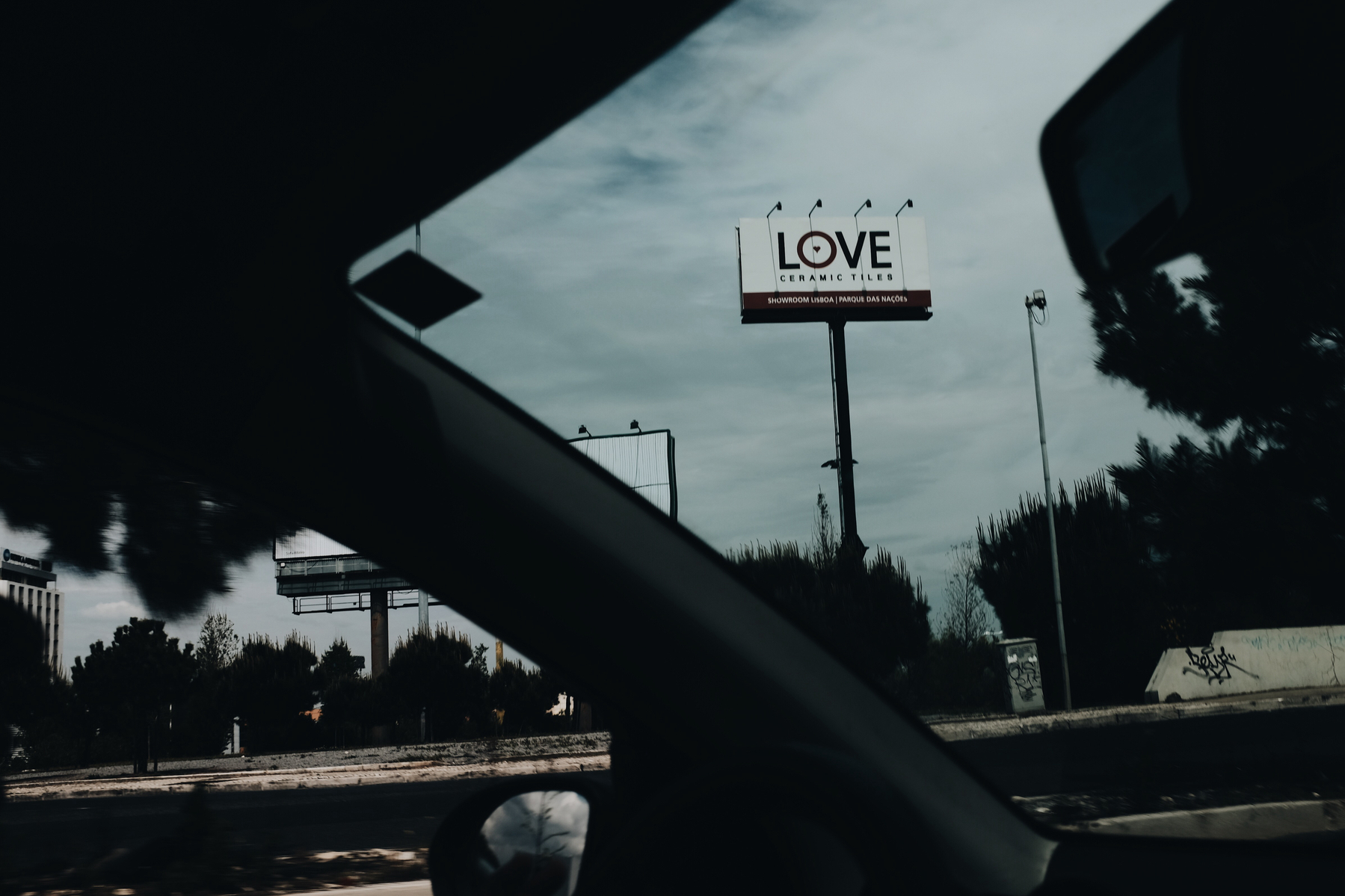 the word “love” is visible from inside a moving car.
