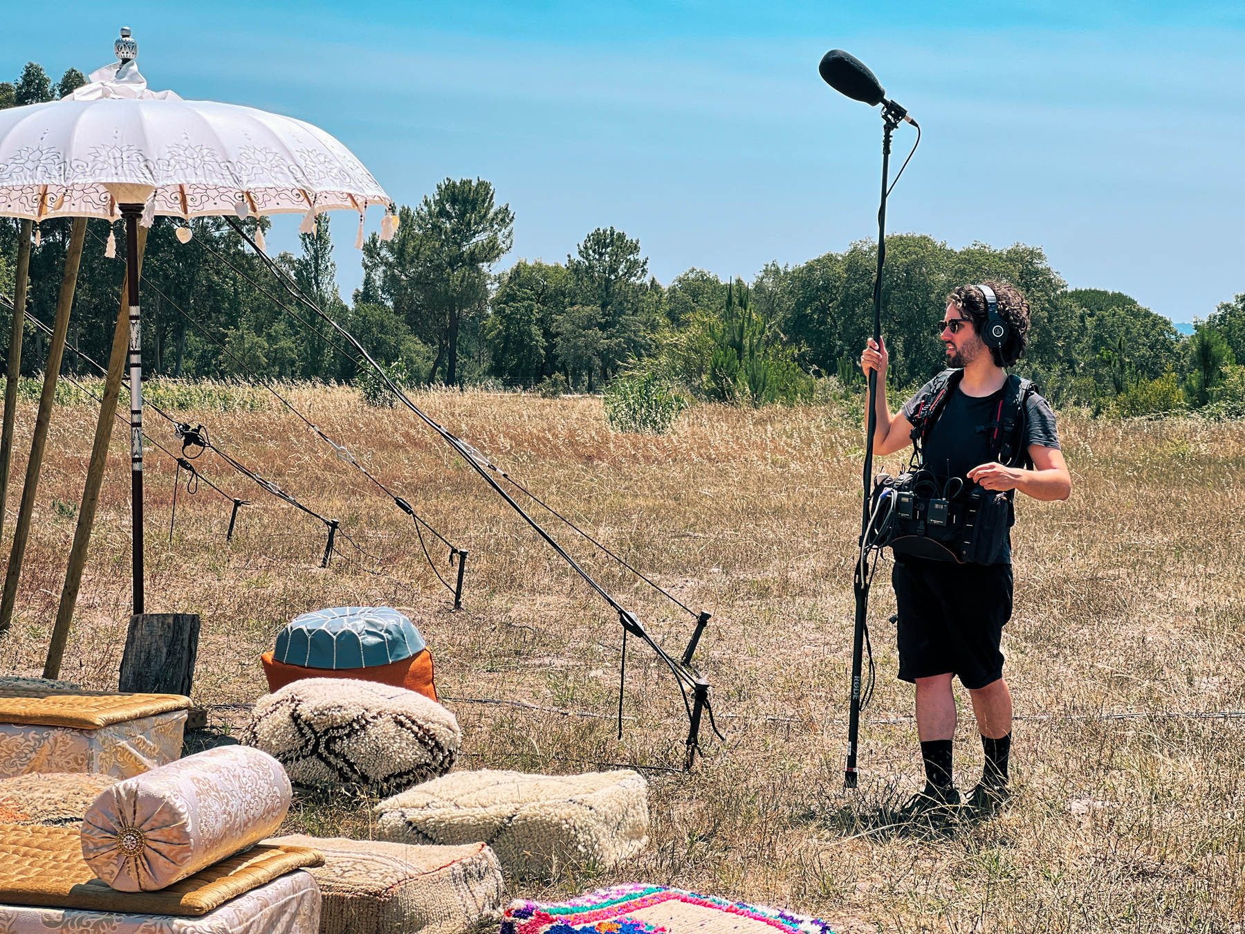 Boom operator, next to a tent. 
