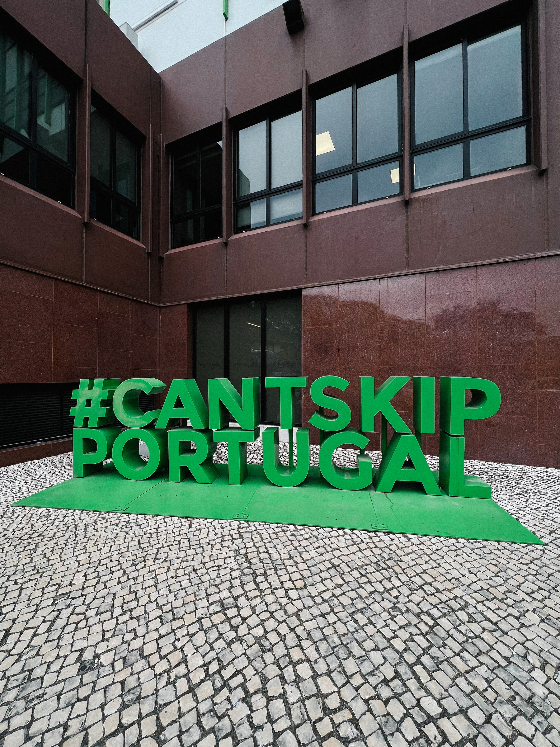 A particularly ugly street corner, with “#cantskipportugal”. 