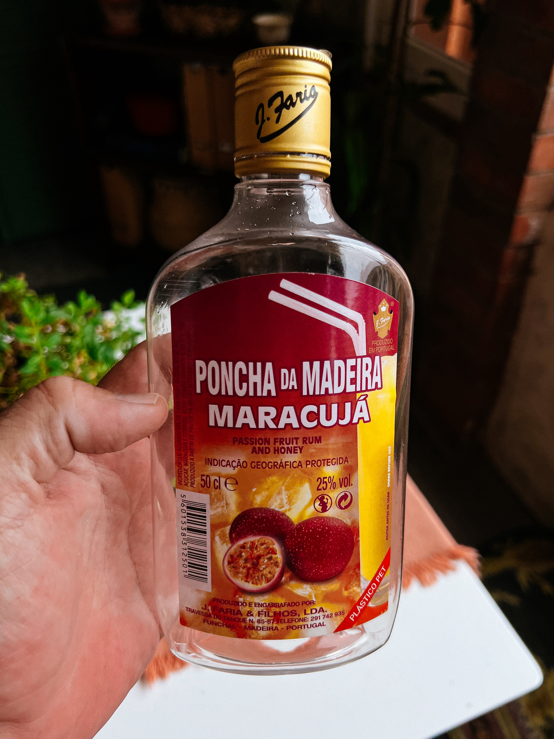 A bottle of Poncha (rum and passion fruit drink).