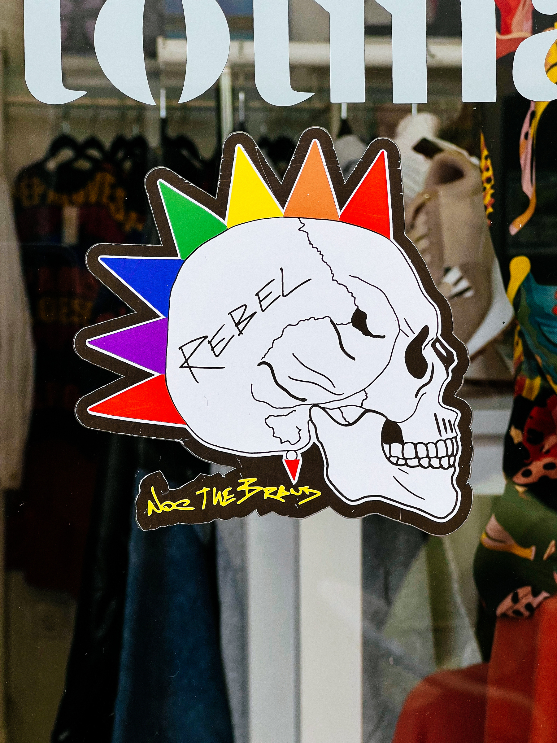 A skull with a rainbow Mohawk. 