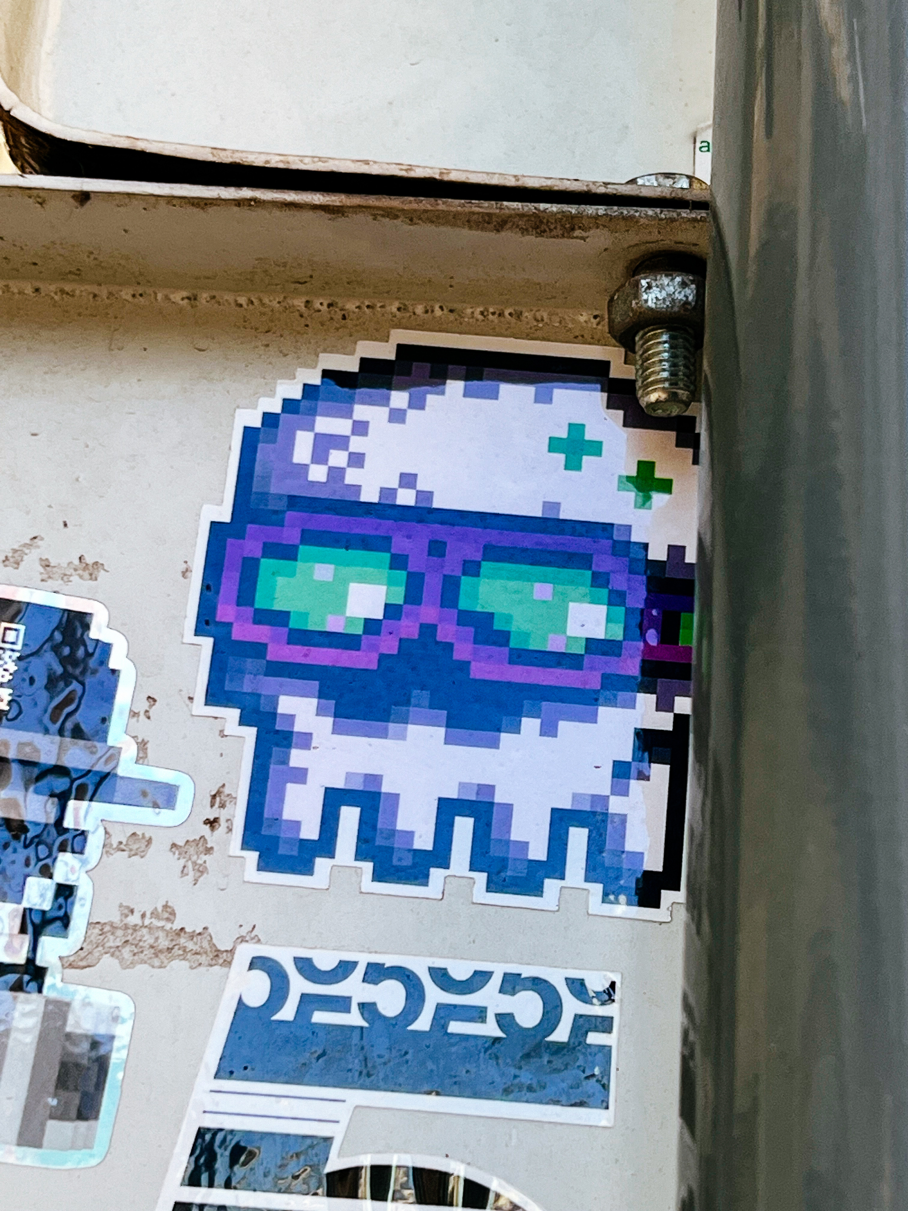 A pixelated squid skull with shades. In a sticker. 