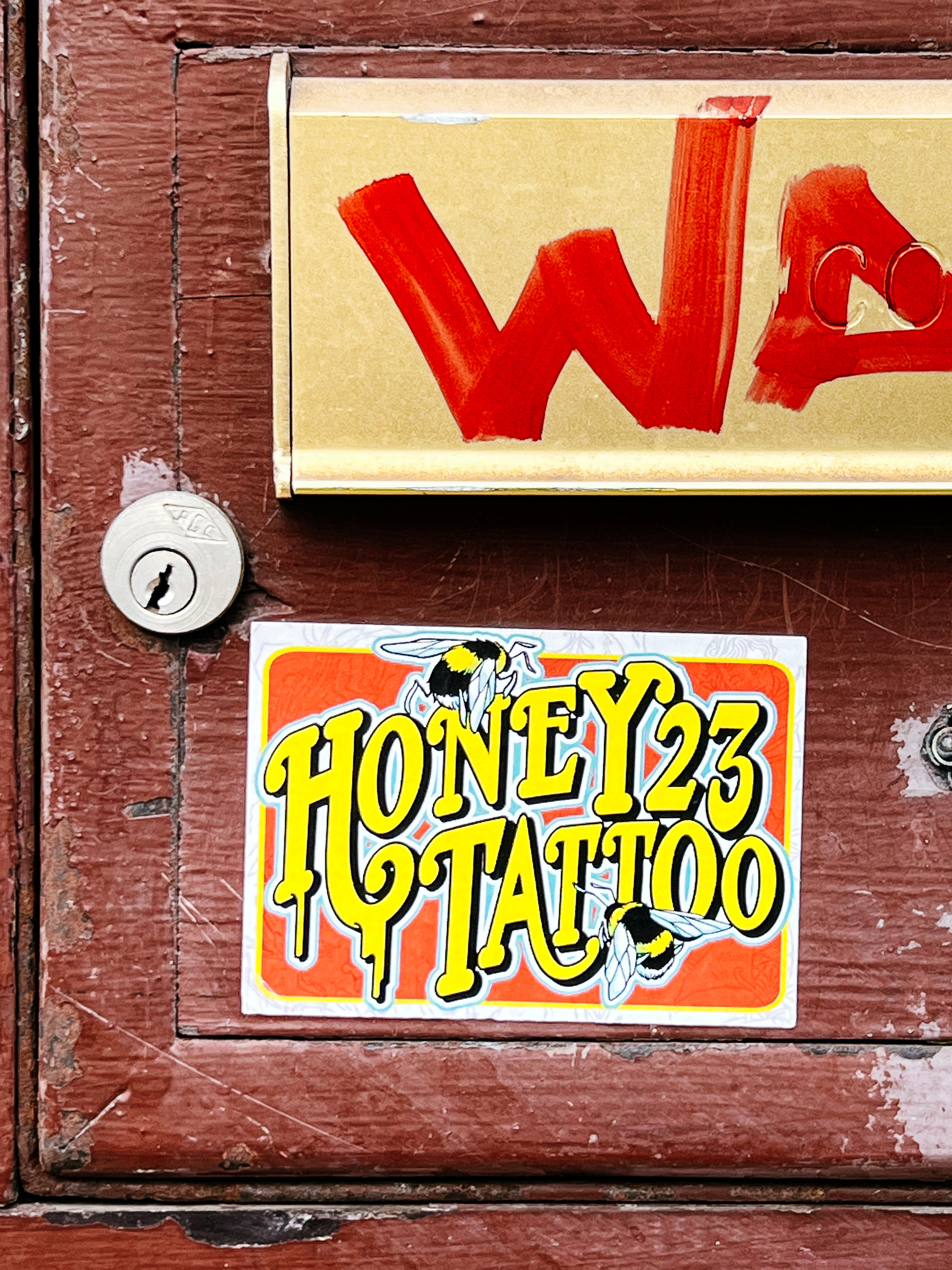 “Honey 23 Tattoo”, and a couple of bees. It’s a sticker. 